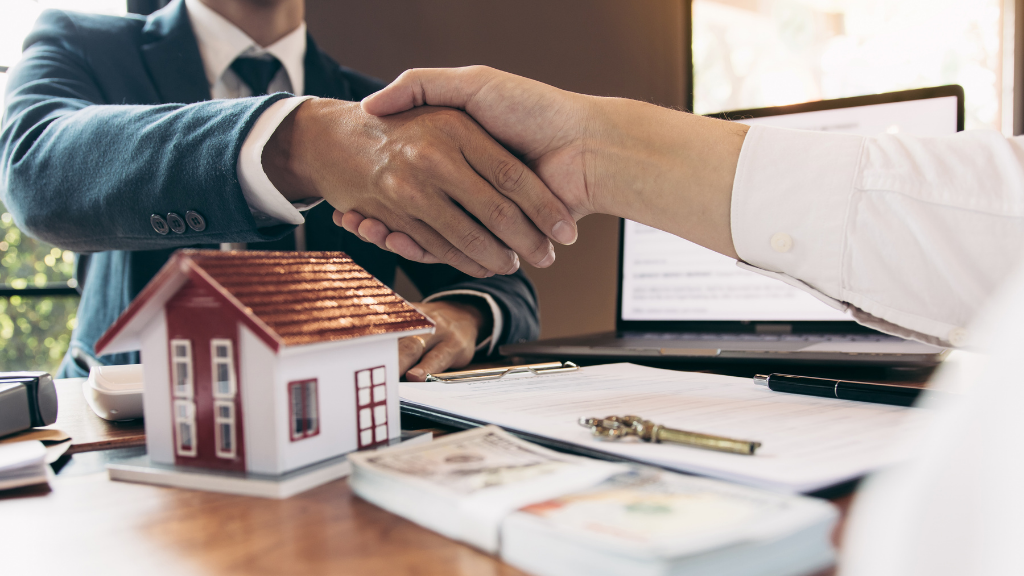 A professional real estate investment scene featuring a handshake between an investor and advisor across a table with a model home, financial documents, cash, and property keys in the foreground. The image symbolizes trust, partnership, and successful real estate transactions. It represents beginner-friendly real estate investing, multifamily investments, passive income, commercial real estate, investment planning, due diligence, property acquisition, financial strategy, wealth building, and the foundational steps to getting started with real estate investing in Albany NY. A professional real estate investment scene featuring a handshake between an investor and advisor across a table with a model home, financial documents, cash, and property keys in the foreground. The image symbolizes trust, partnership, and successful real estate transactions. It represents beginner-friendly real estate investing, multifamily investments, passive income, commercial real estate, investment planning, due diligence, property acquisition, financial strategy, wealth building, and the foundational steps to getting started with real estate investing in Albany NY.