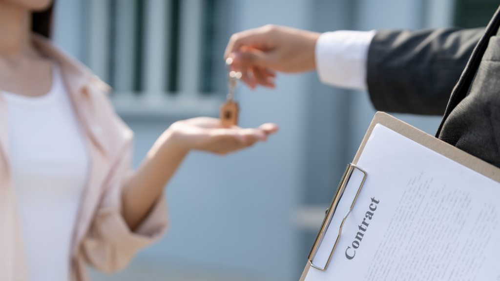 A close-up of a real estate professional handing house keys to a new property owner while holding a contract clipboard. The image represents successful property transactions, home purchases, closing agreements, and key handovers. It supports topics such as multifamily investing, commercial real estate, property acquisitions, investment closings, buyer representation, real estate transactions, and securing investment properties in Albany NY. A close-up of a real estate professional handing house keys to a new property owner while holding a contract clipboard. The image represents successful property transactions, home purchases, closing agreements, and key handovers. It supports topics such as multifamily investing, commercial real estate, property acquisitions, investment closings, buyer representation, real estate transactions, and securing investment properties in Albany NY.