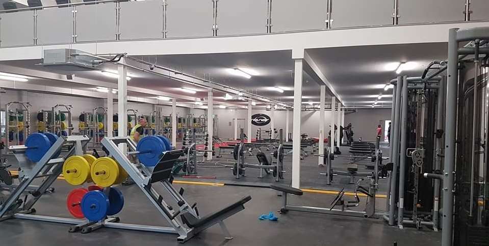 Weights and strength-training area within a completed FLYEfit gym