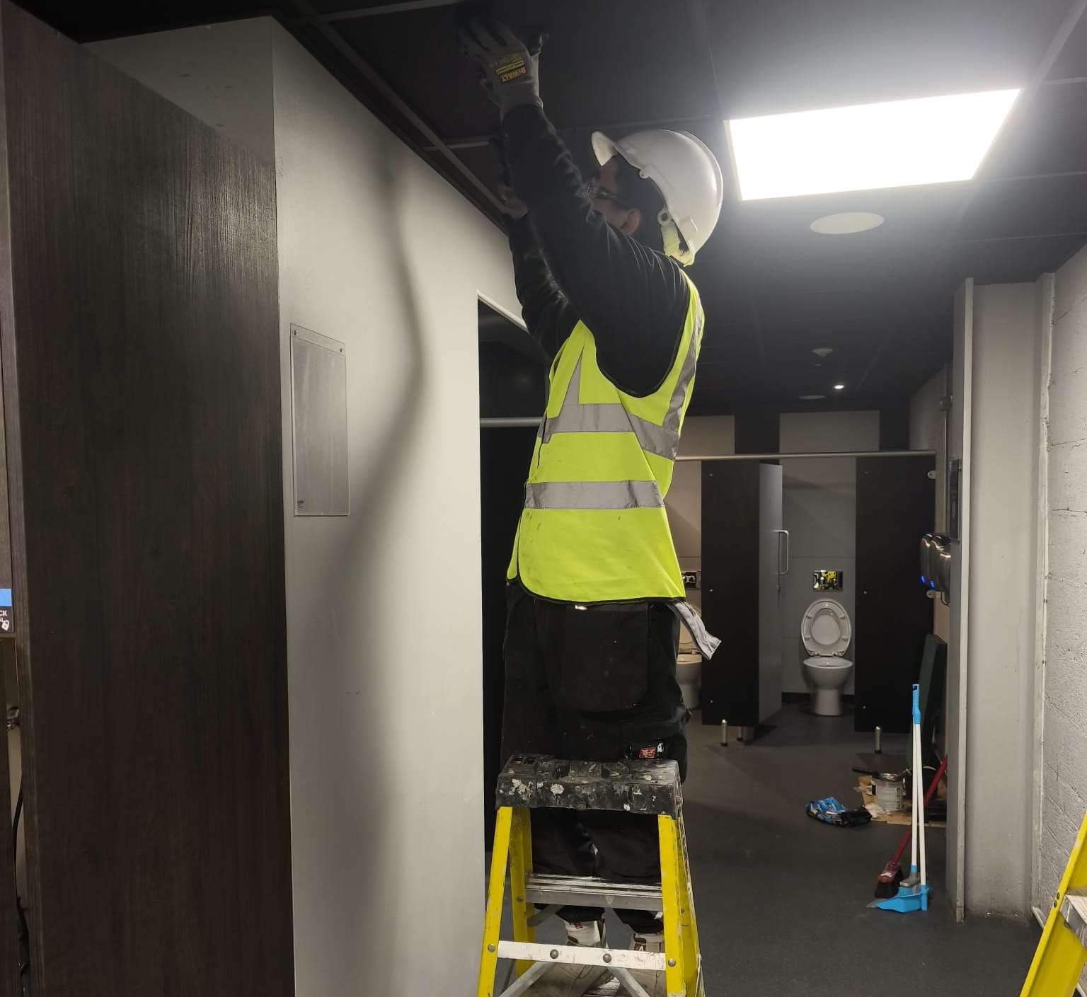 Metalwork installation being completed within an operational property