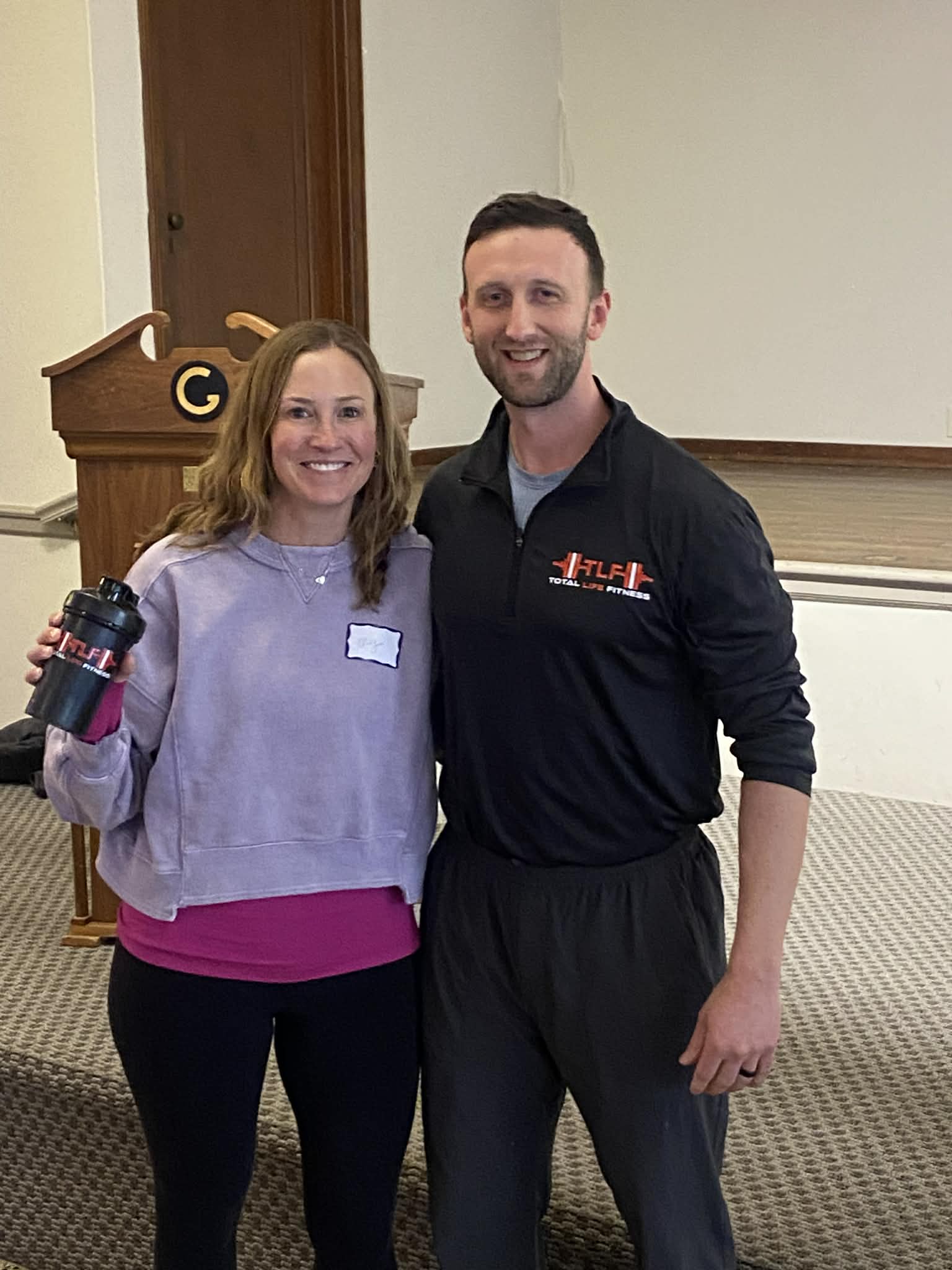 Total Life Fitness coach with a program member