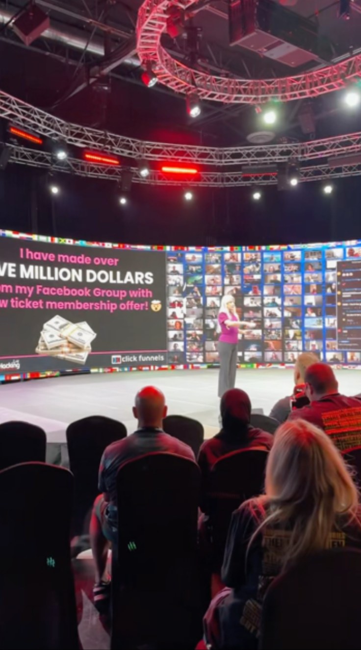 Christina Rowe speaking on the Funnel Hacking Live stage in front of a ClickFunnels screen and a live audience