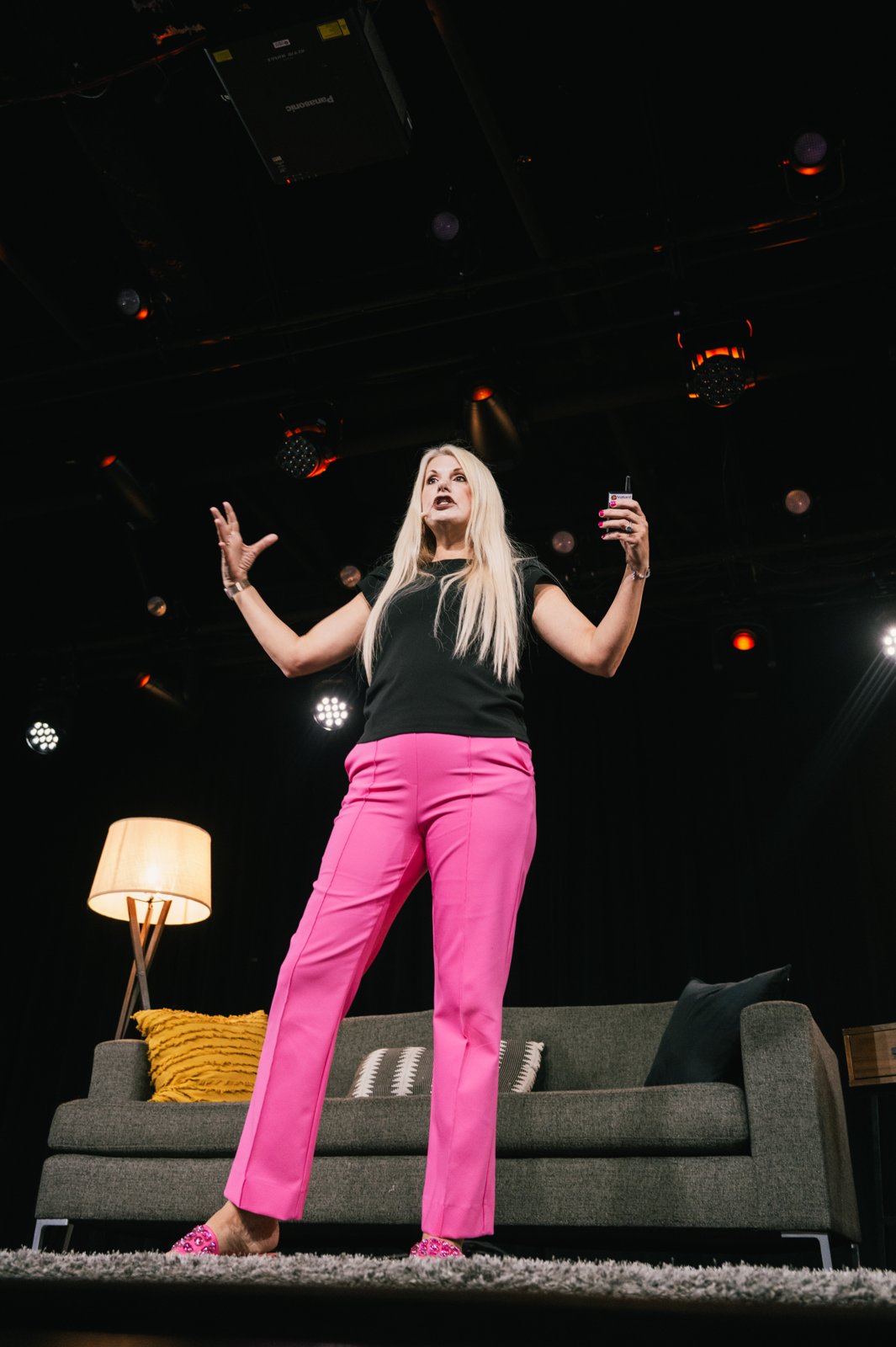 Christina Rowe speaking on a dark stage