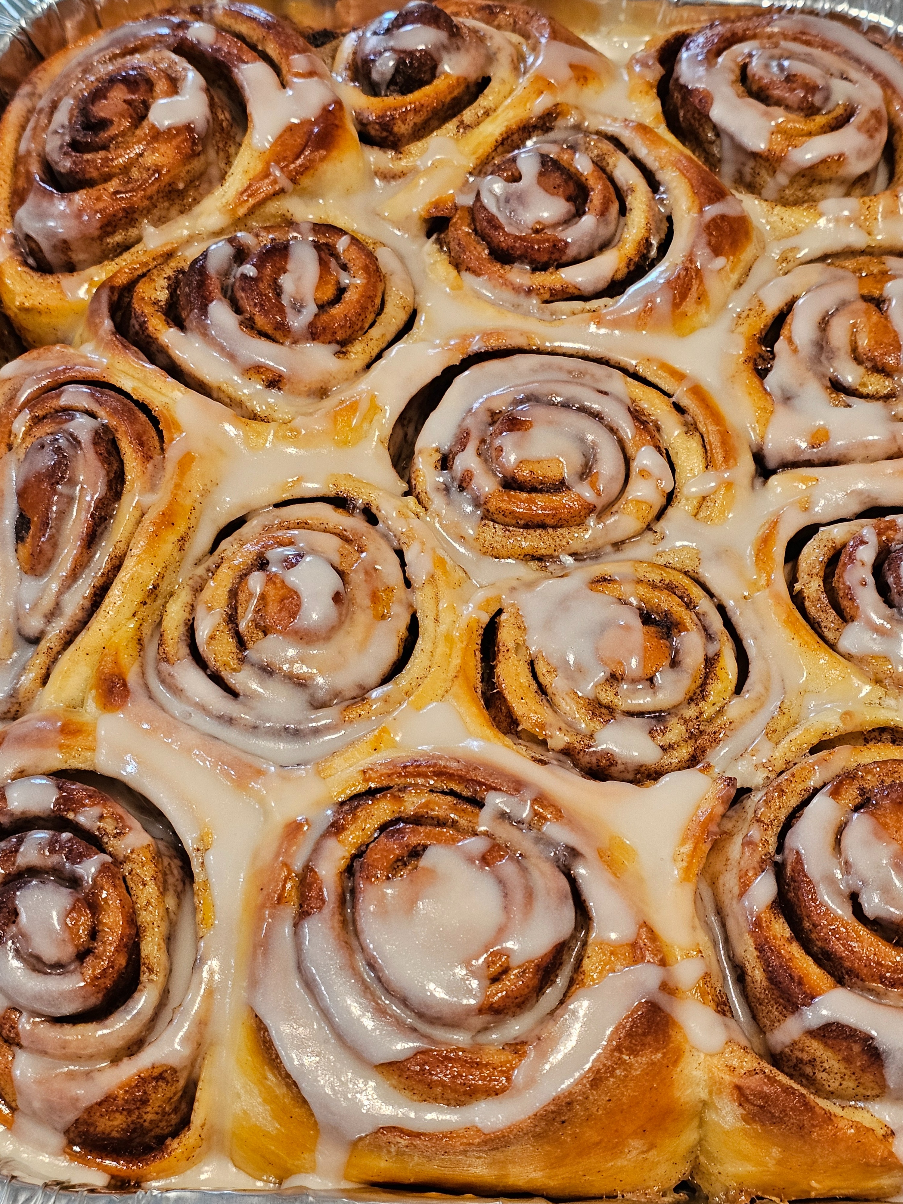 Fresh cinnamon rolls on a cooling rack