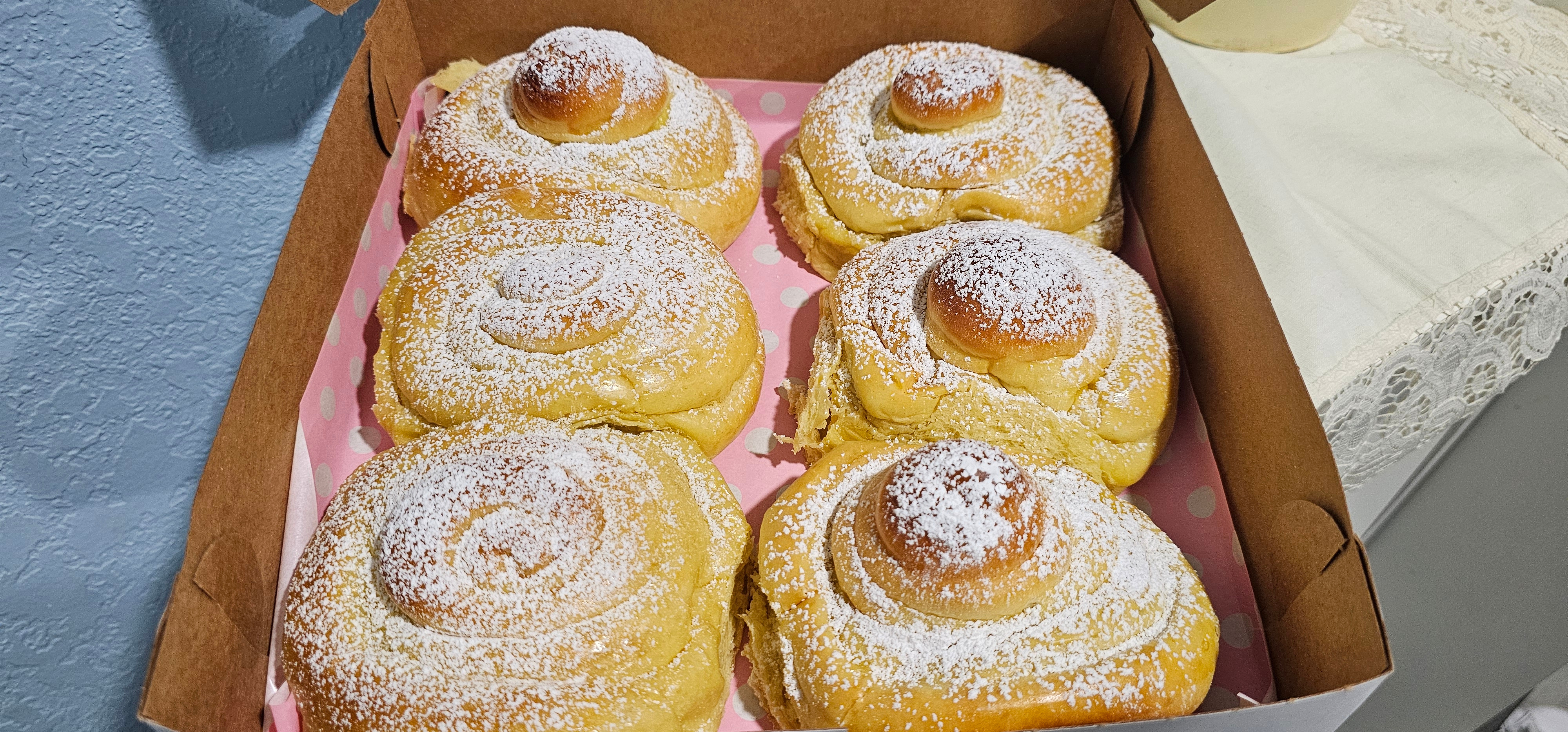 Puerto Rican mallorca bread rolls dusted with powdered sugar