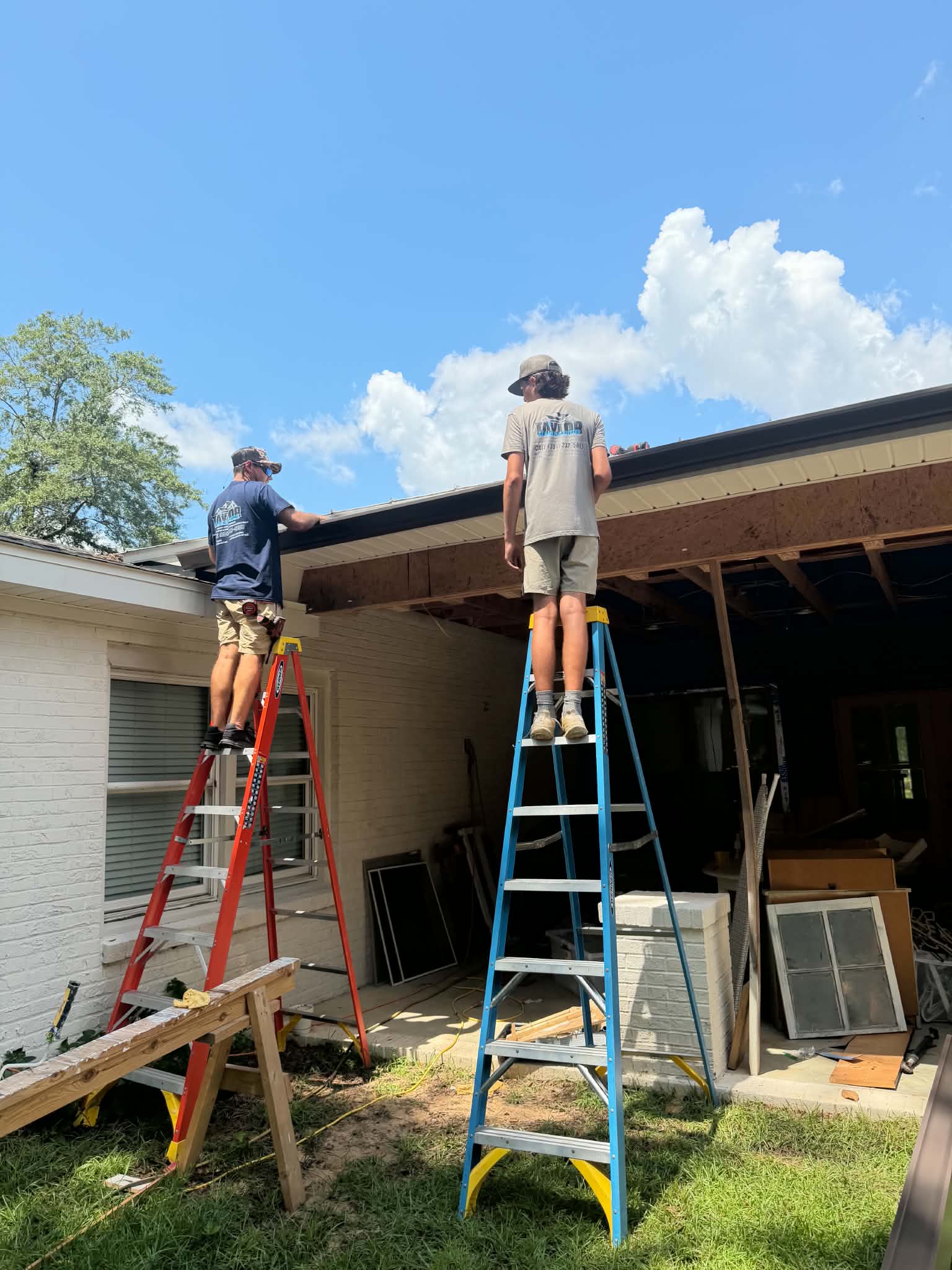 Taylor Seamless Gutters family working together on a gutter installation
