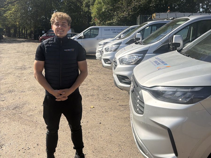 Dylan standing beside a row of Clear View vans