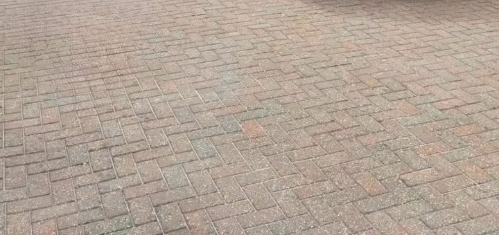 After: the same driveway with the block paving clean and red