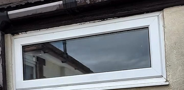 After: the same window, with the frame and sill clean and white
