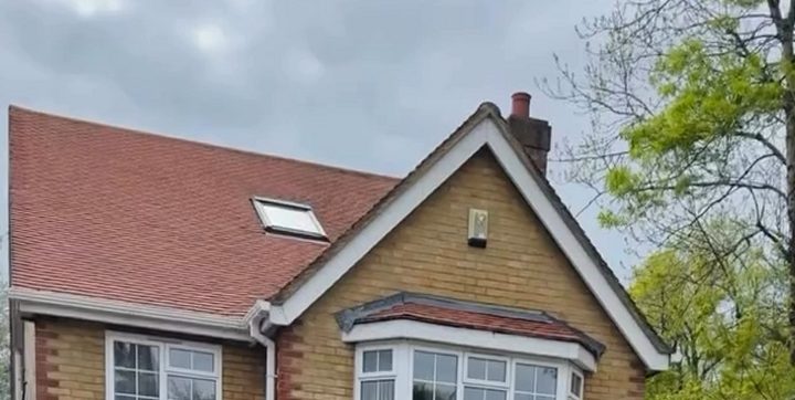 After: the same roof cleaned, with the tiles back to a bright red