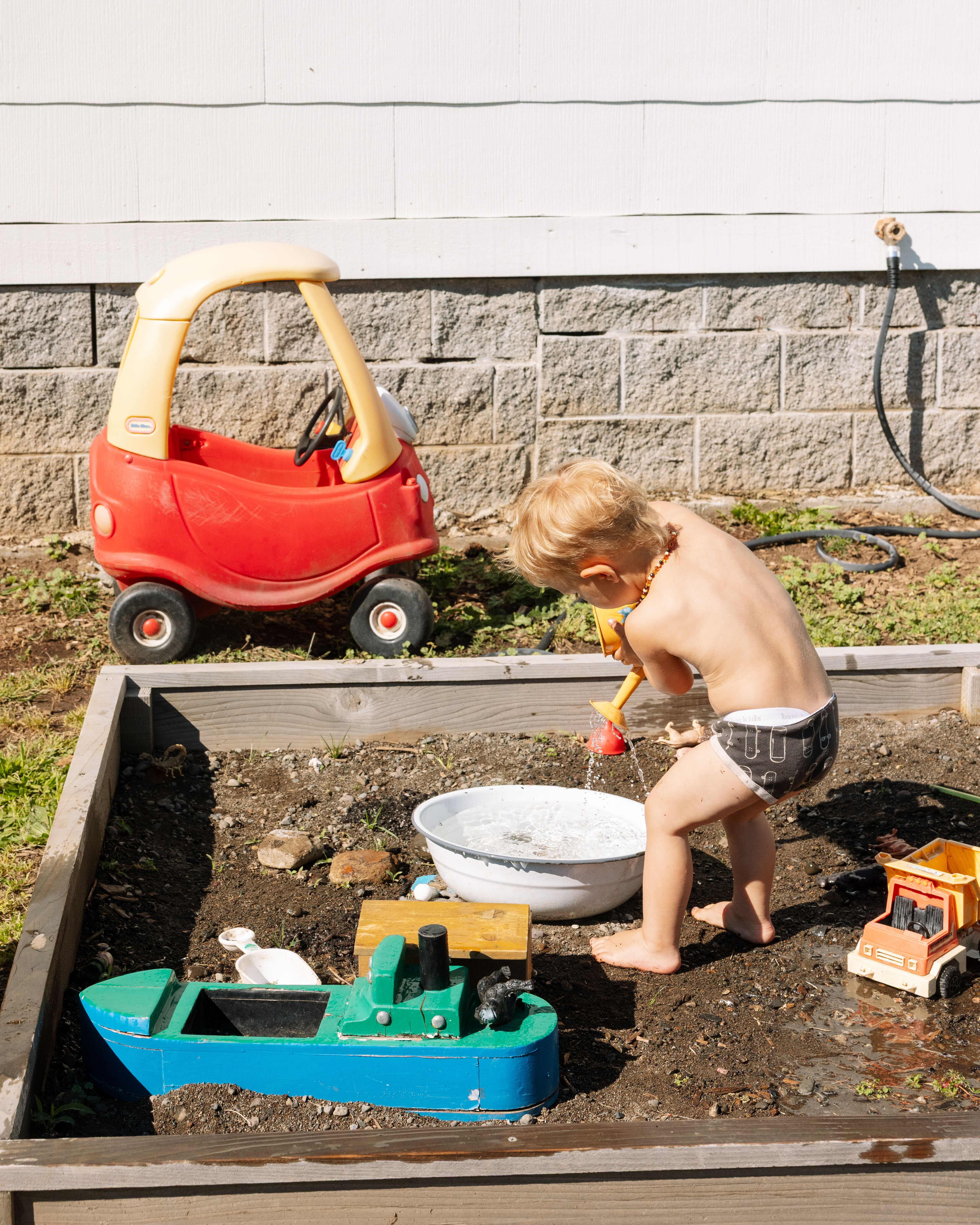 A Mother's Natural Summer child playing with chalk