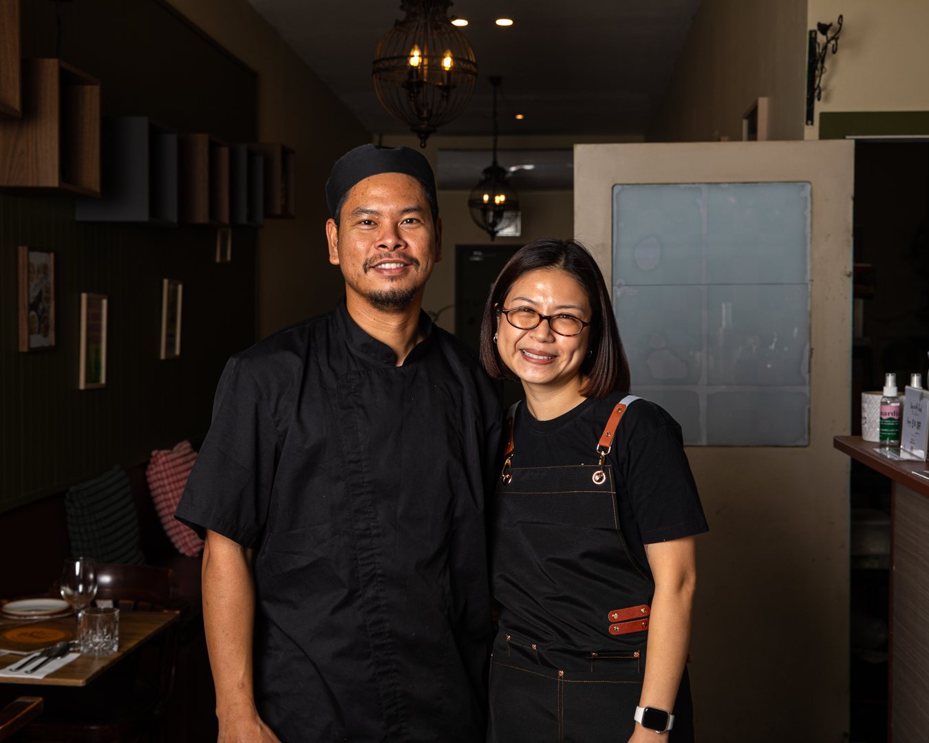 The chef and owner of D.C. Thai smiling together in the restaurant dining room