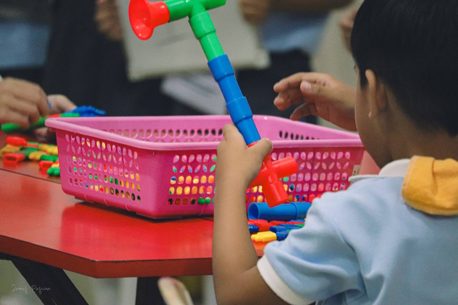 A preschooler learning through hands-on play