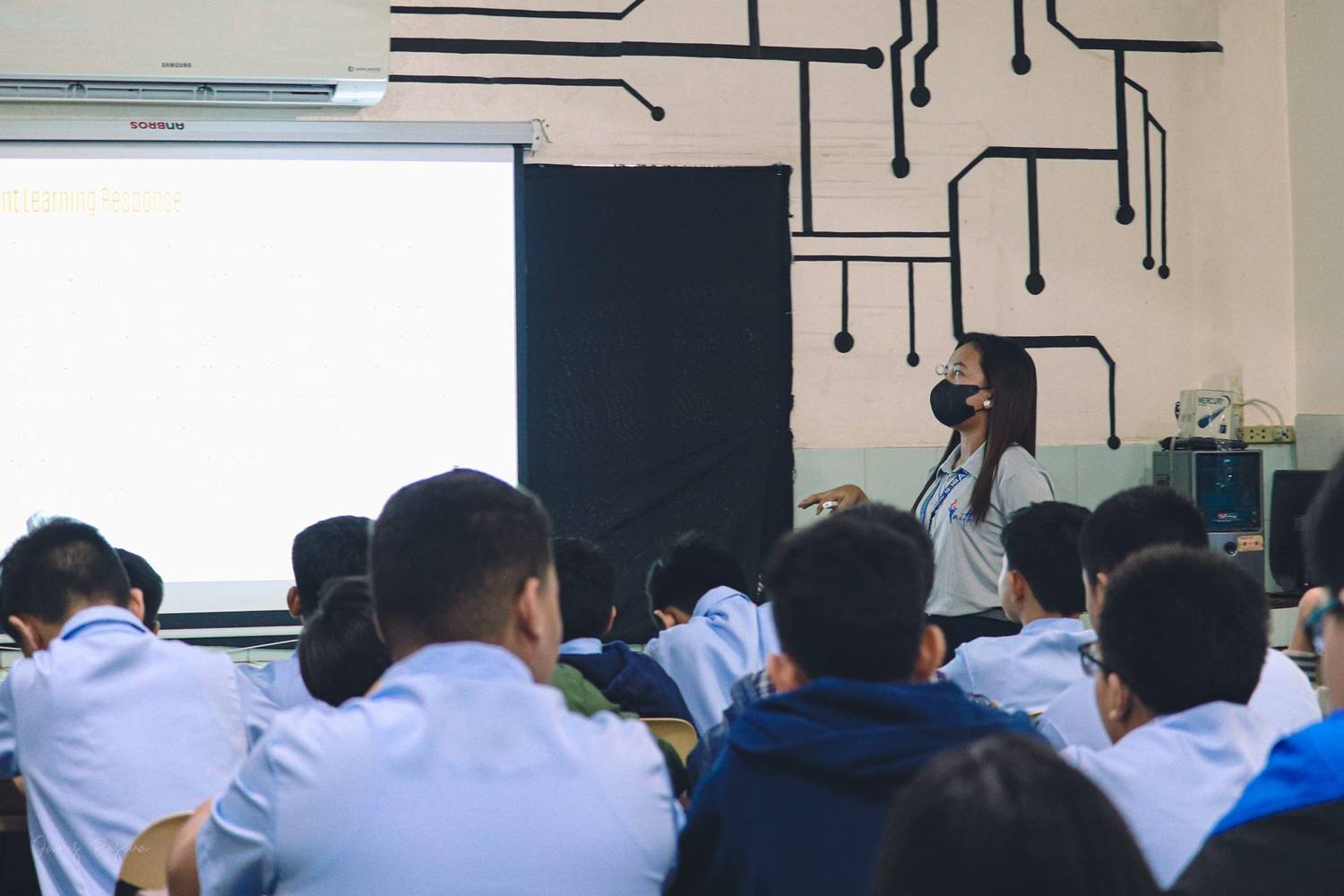 Junior high students listening to their teacher