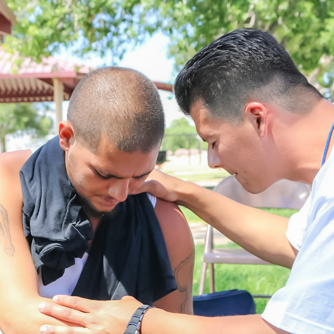 Men praying together during recovery