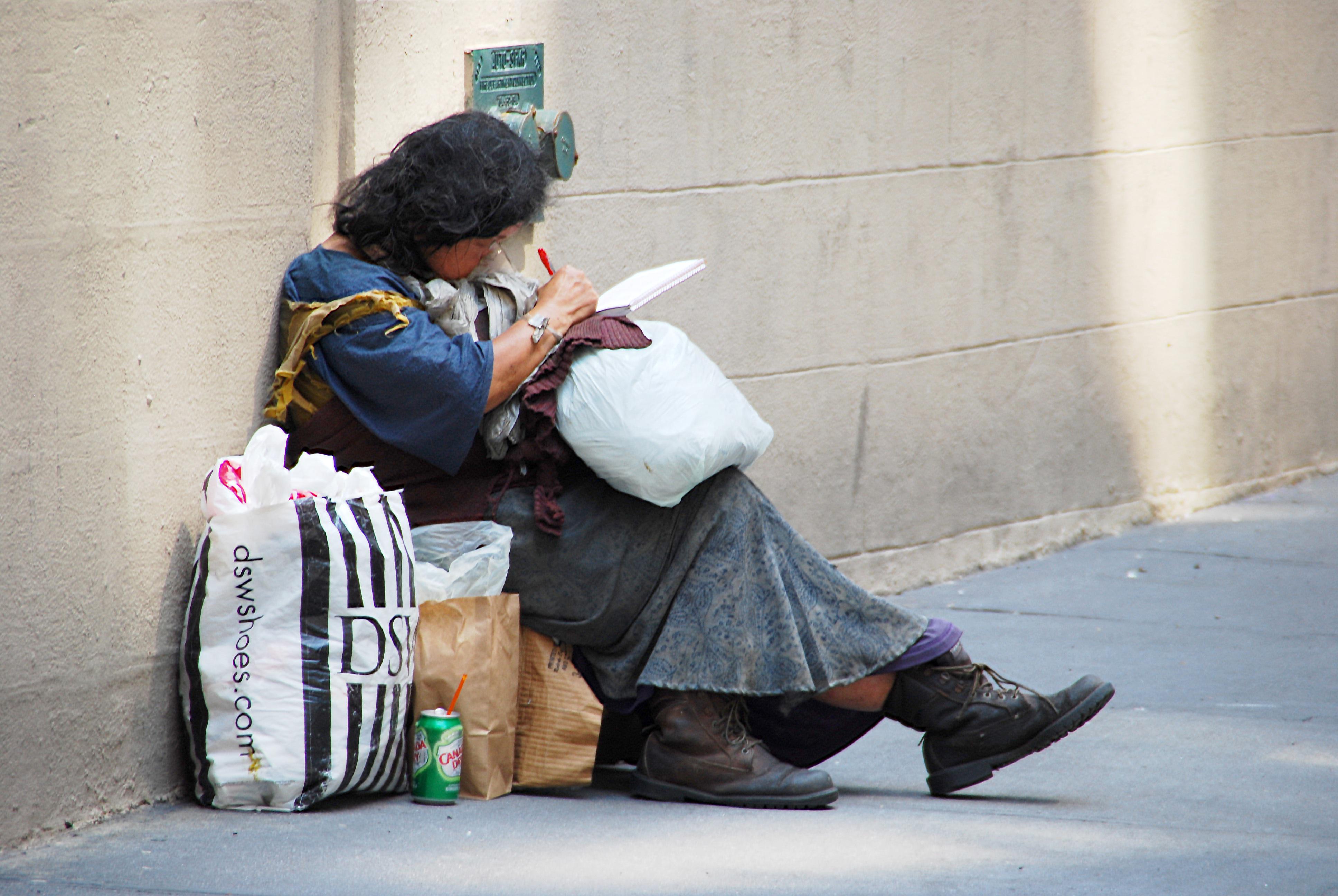 A woman facing homelessness sitting outside