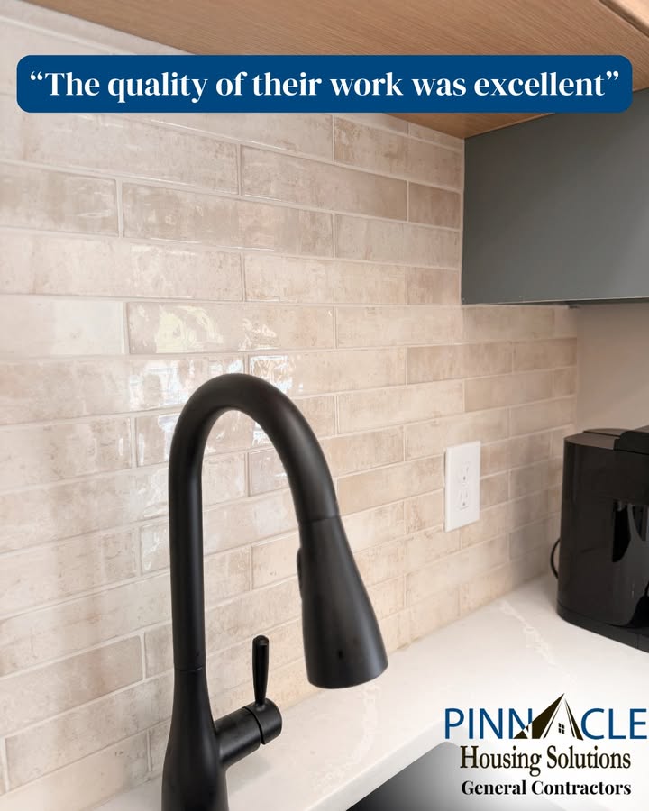 Cream glossy tile backsplash, black faucet and light countertop at a finished basement bar in Chester County, PA.