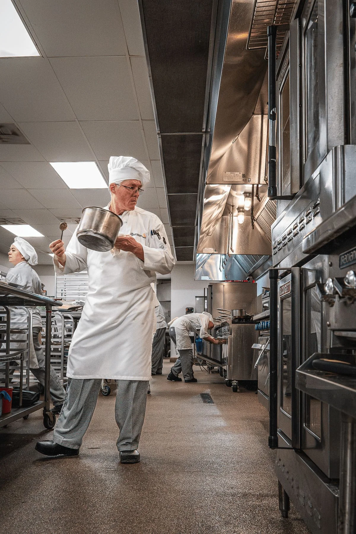 Professional chef instructor in a commercial kitchen at CSFTW
