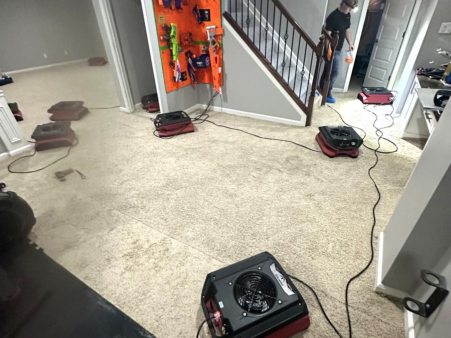 Commercial air movers running during the structural drying stage of a restoration job