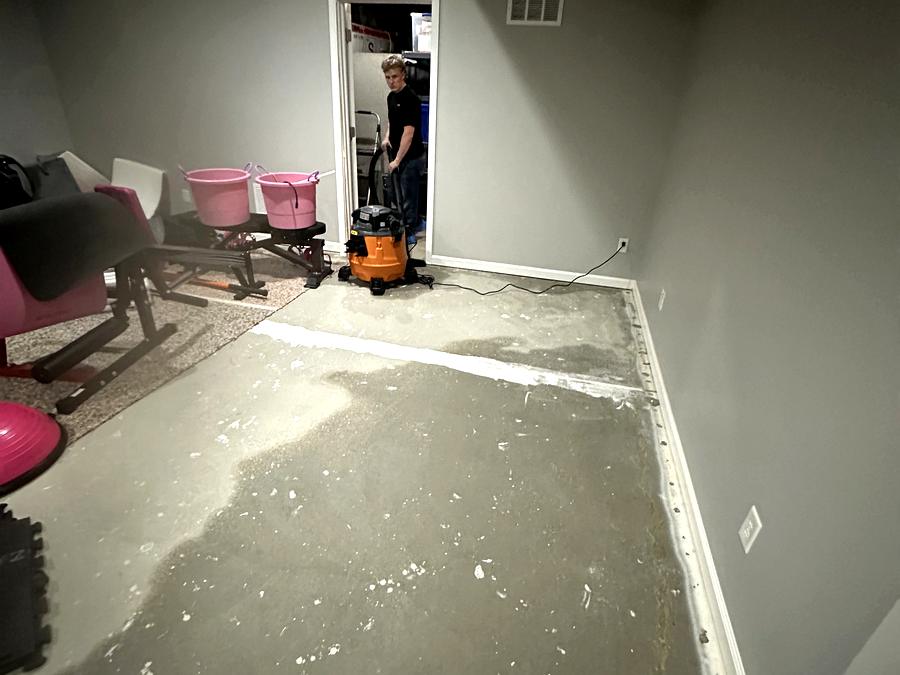 Callie Enterprises technician extracting standing water from a basement floor