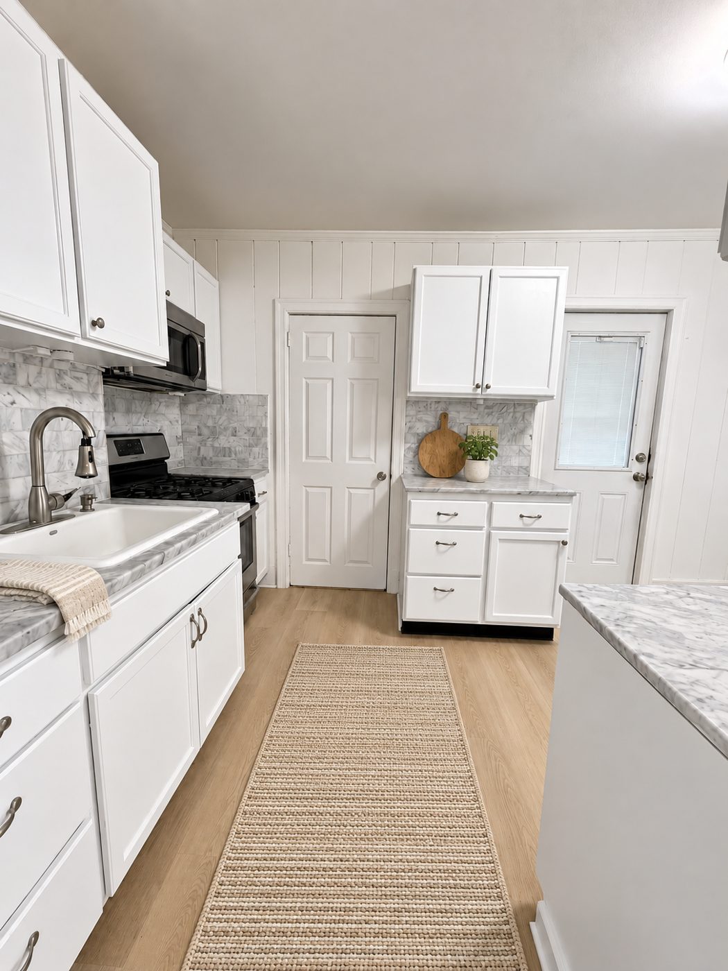 Renovated galley kitchen with shaker cabinetry
