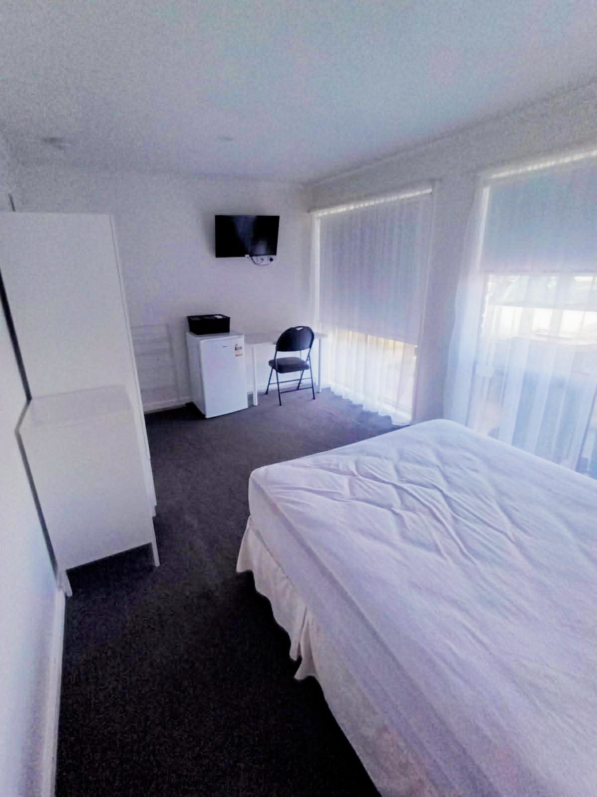 Room with fridge and TV