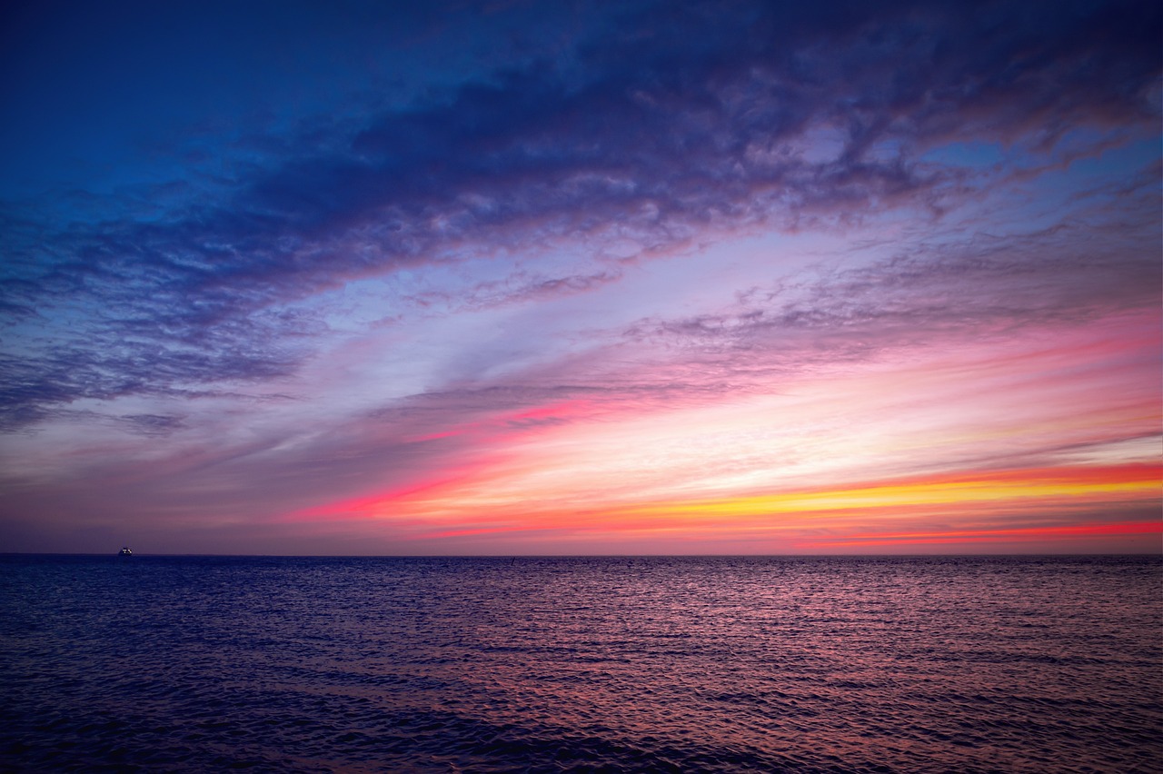 beach at sunset with purple skies