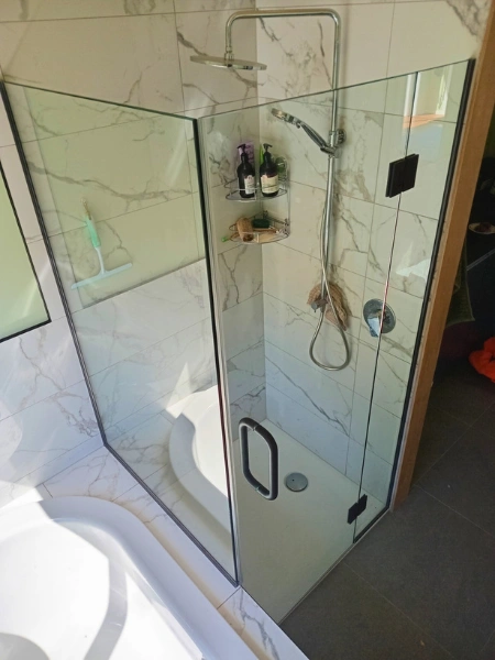 Custom frameless glass shower enclosure installed in Wellington bathroom