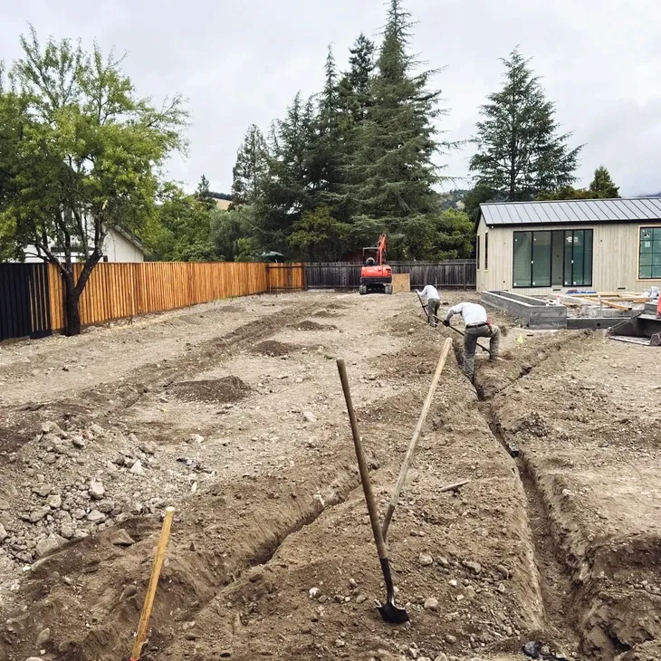 Wine Country Landscaping crew trenching for a new irrigation and drainage system in Sonoma