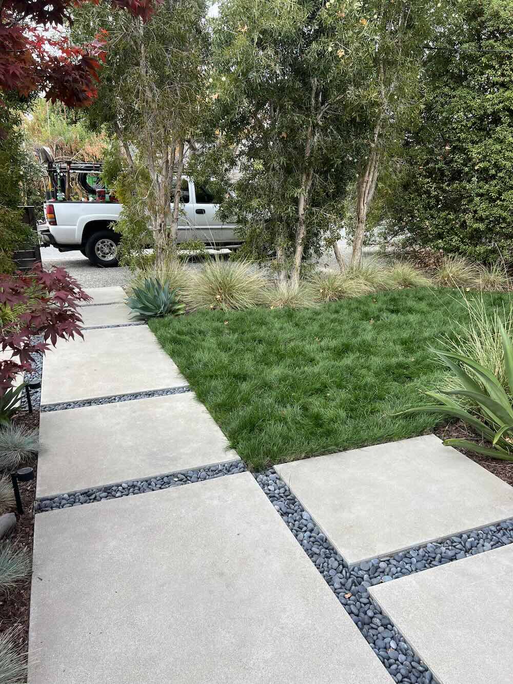 Freshly maintained lawn and flagstone path in Sonoma, Wine Country Landscaping truck in back