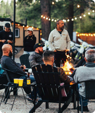 Luxvoni team gathering by fire in Big Bear for Motorcycle Retreat with ALIV