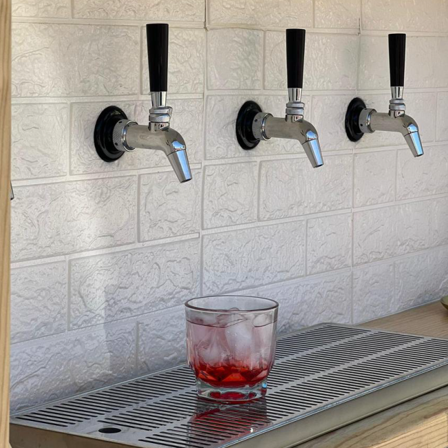 A close-up of the four taps and a drink