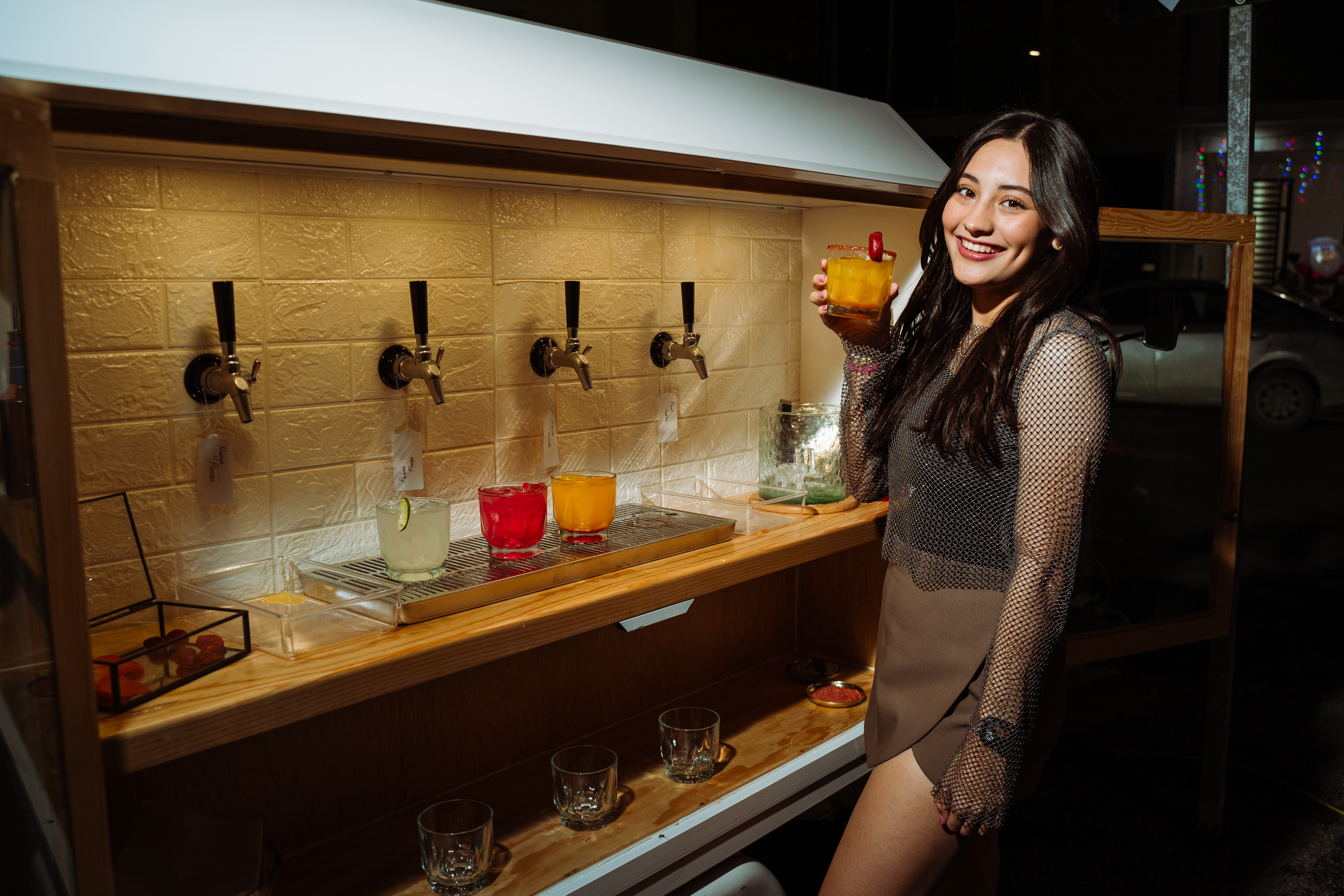A guest enjoying a drink beside the Mila Bar cart