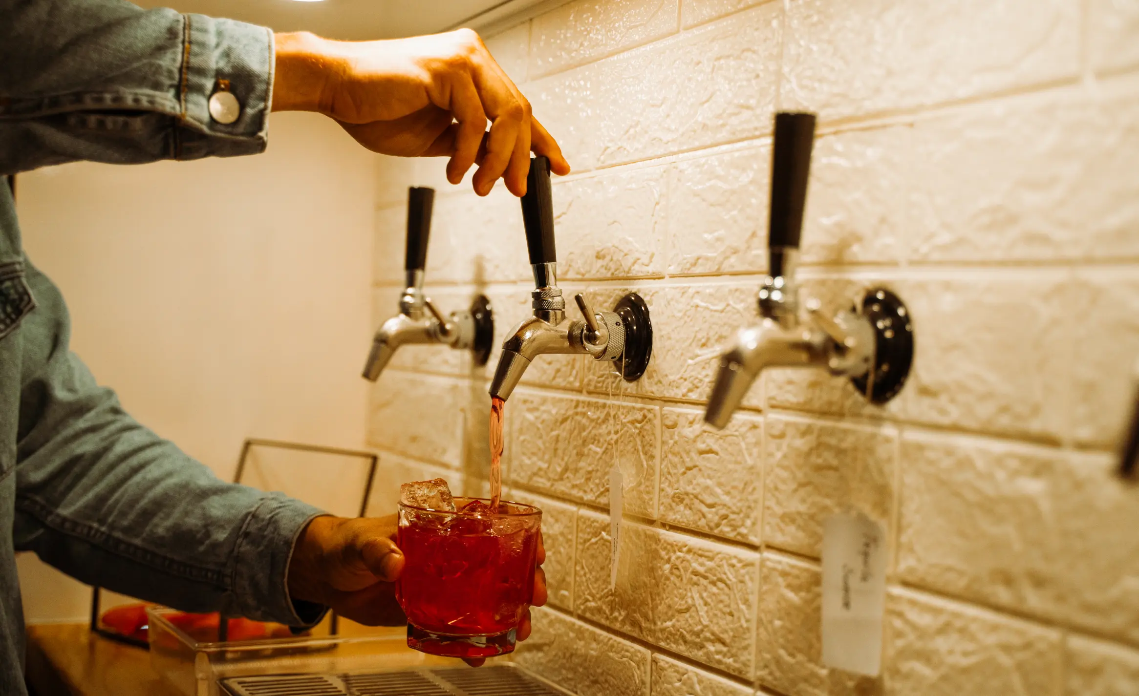 A drink being poured from a Mila Bar tap