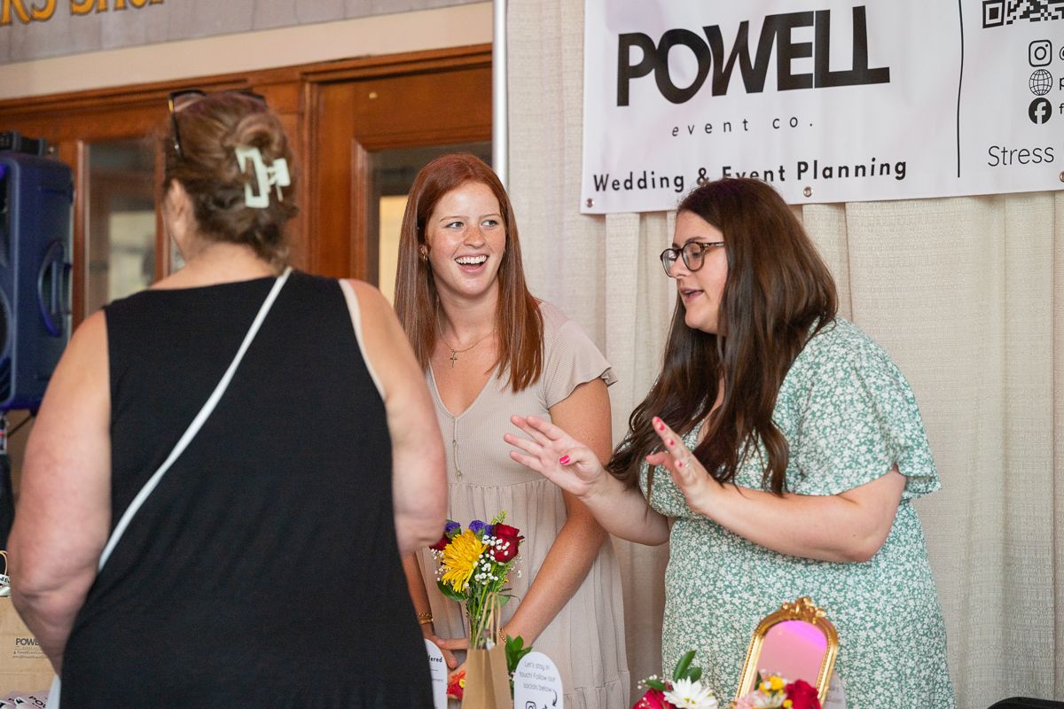 Wedding planners talking with a guest