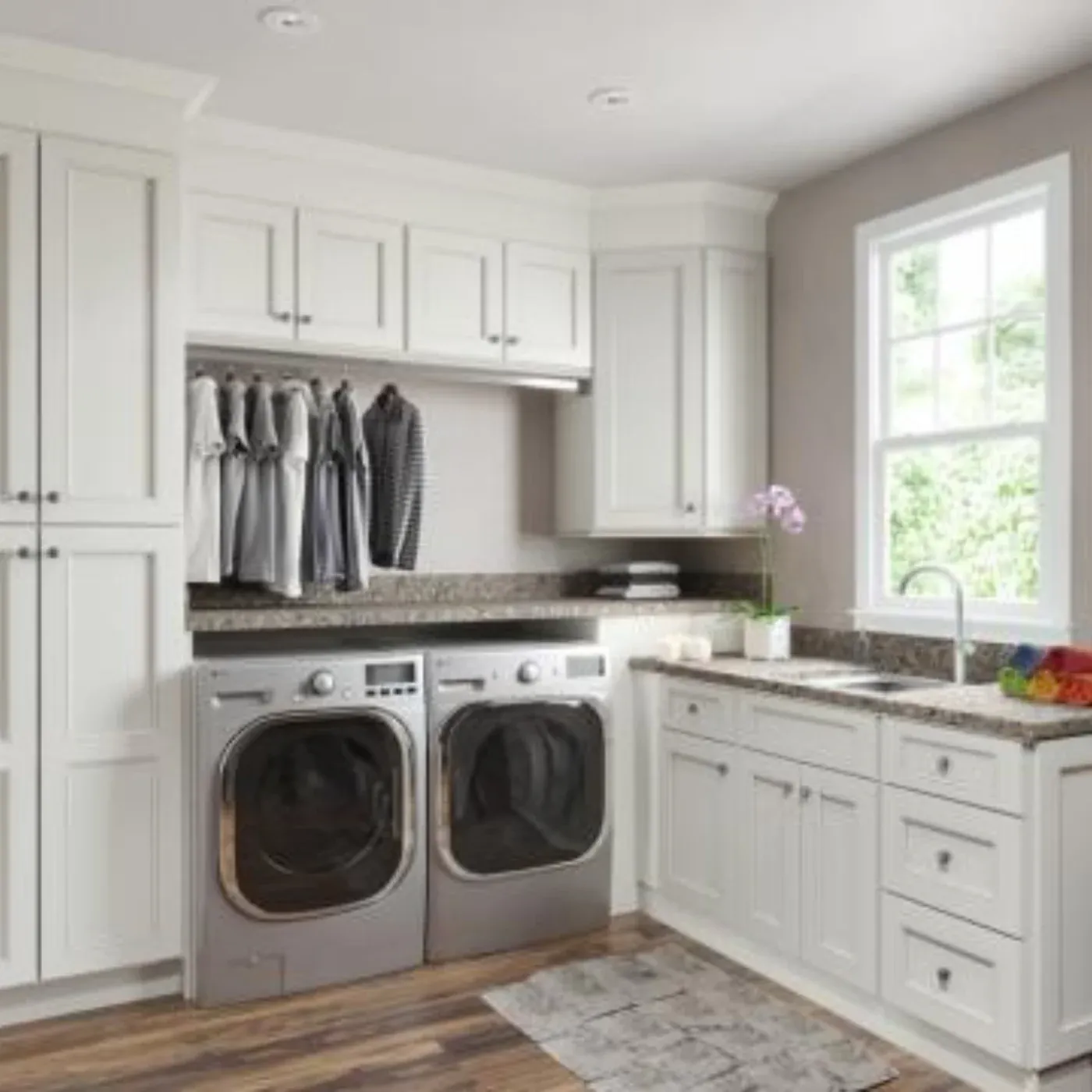 White laundry room cabinets with a counter and sink