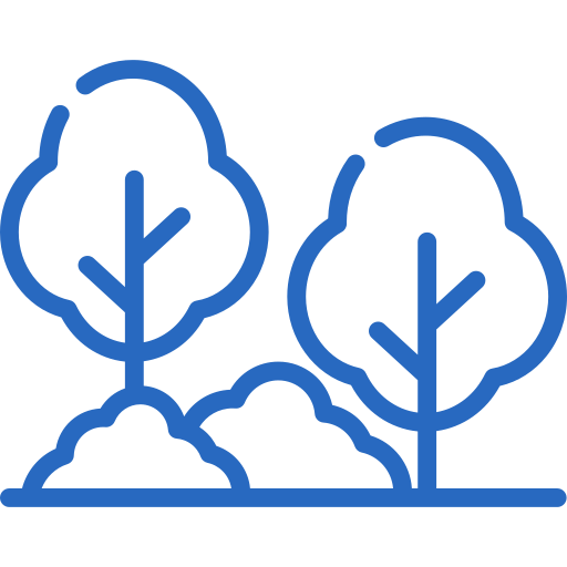 A man in a yellow cap and white shirt assembling furniture on the floor, holding a wrench.