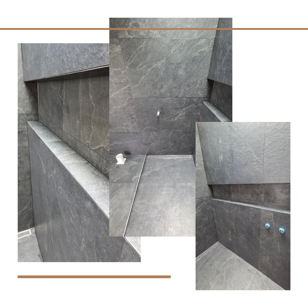 Kerikeri bathroom tiling with large black rock pattern tiles, mitred niches, and sandstone mosaic detail by FS Tiling