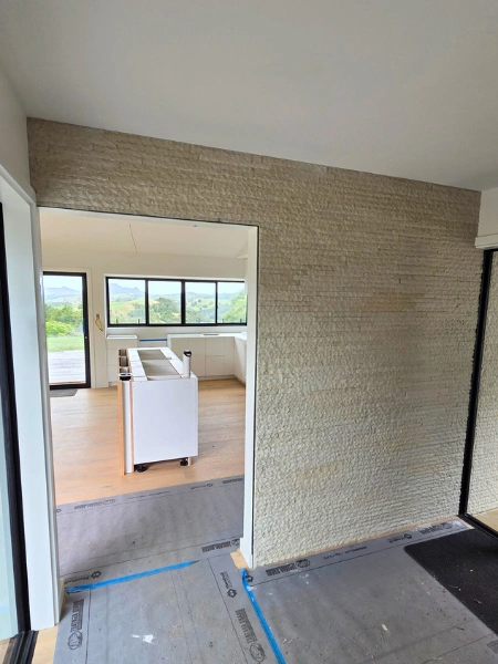 Interior lounge feature wall in Kerikeri with natural stone style finish