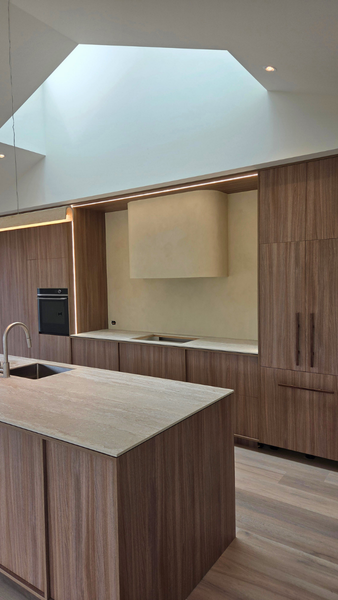 Microcement kitchen splashback and rangehood in Northland home with minimalist waterproof design