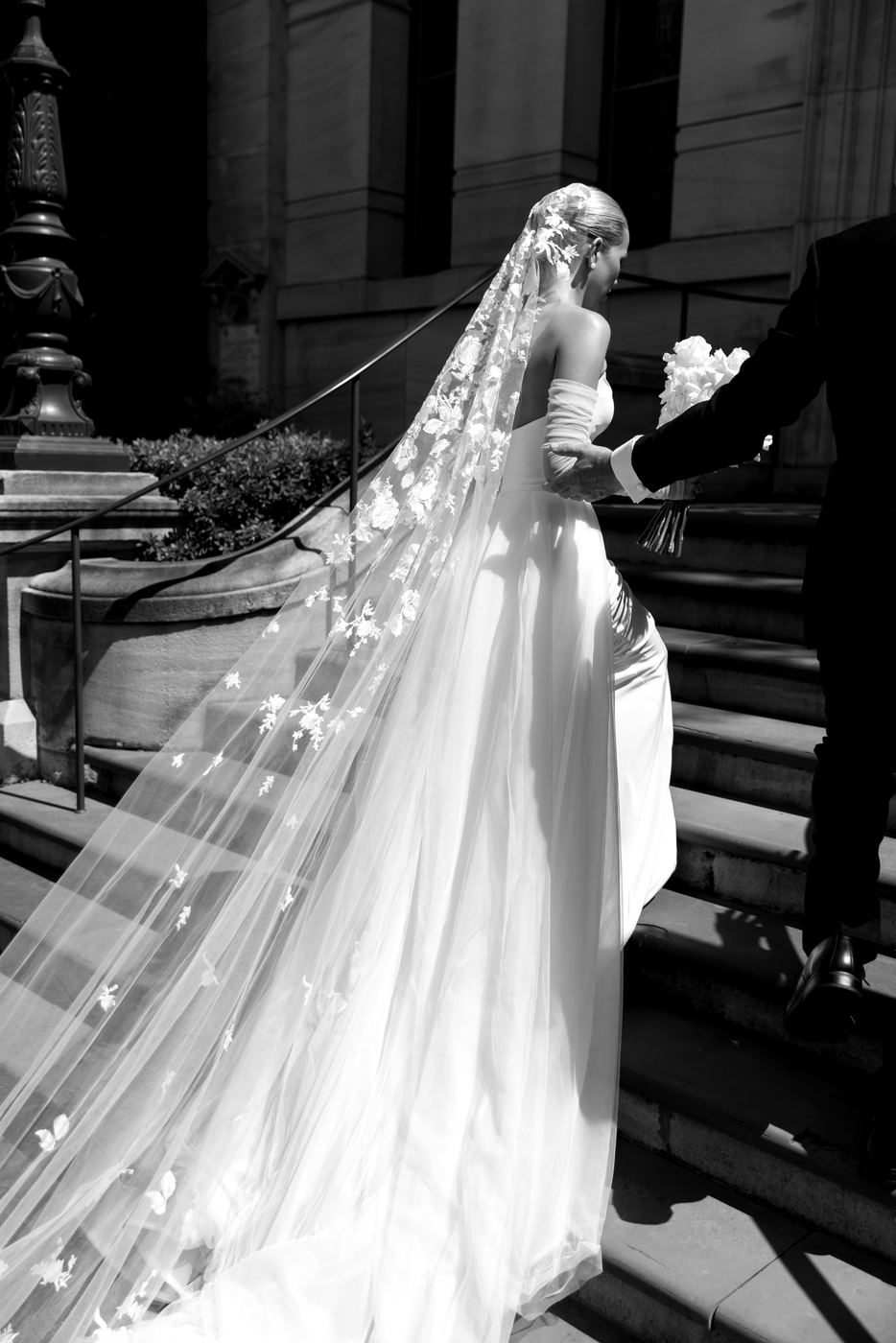An embroidered veil trailing down sandstone stairs