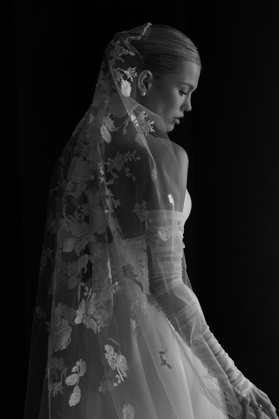 Bride in profile beneath an embroidered veil