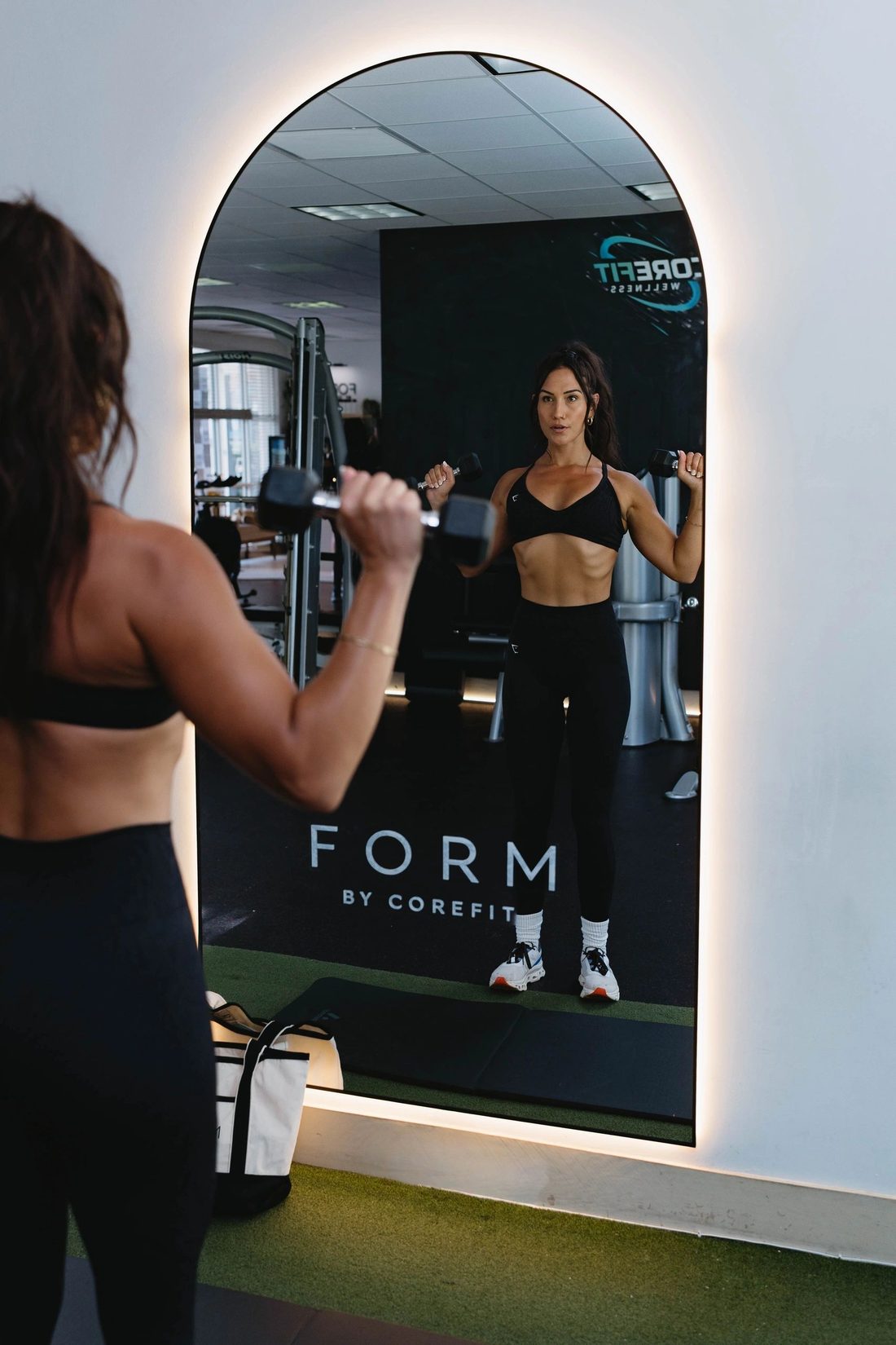 A FORM by CoreFit member in the studio mirror