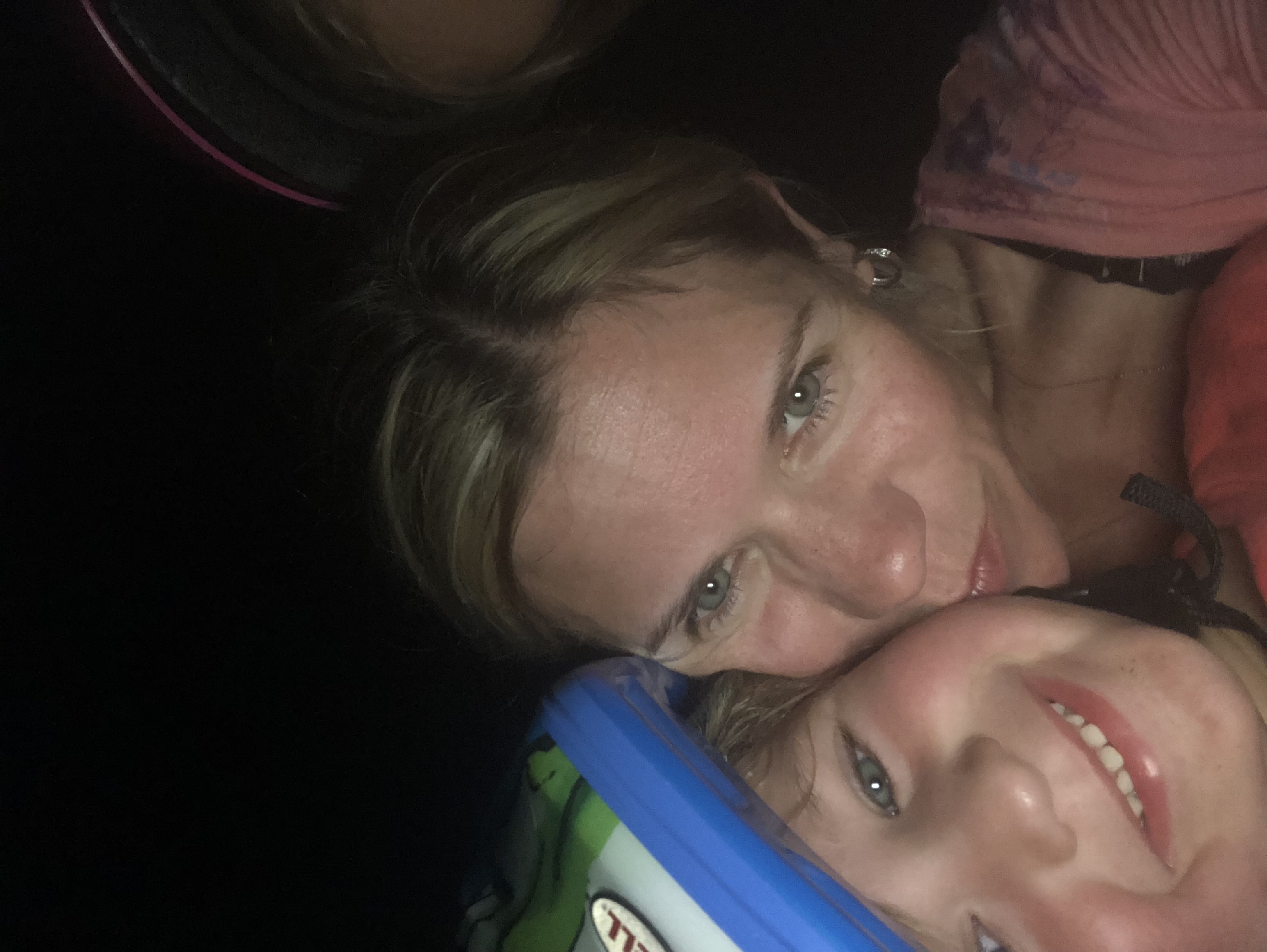 Coach sitting on the floor connecting with a toddler