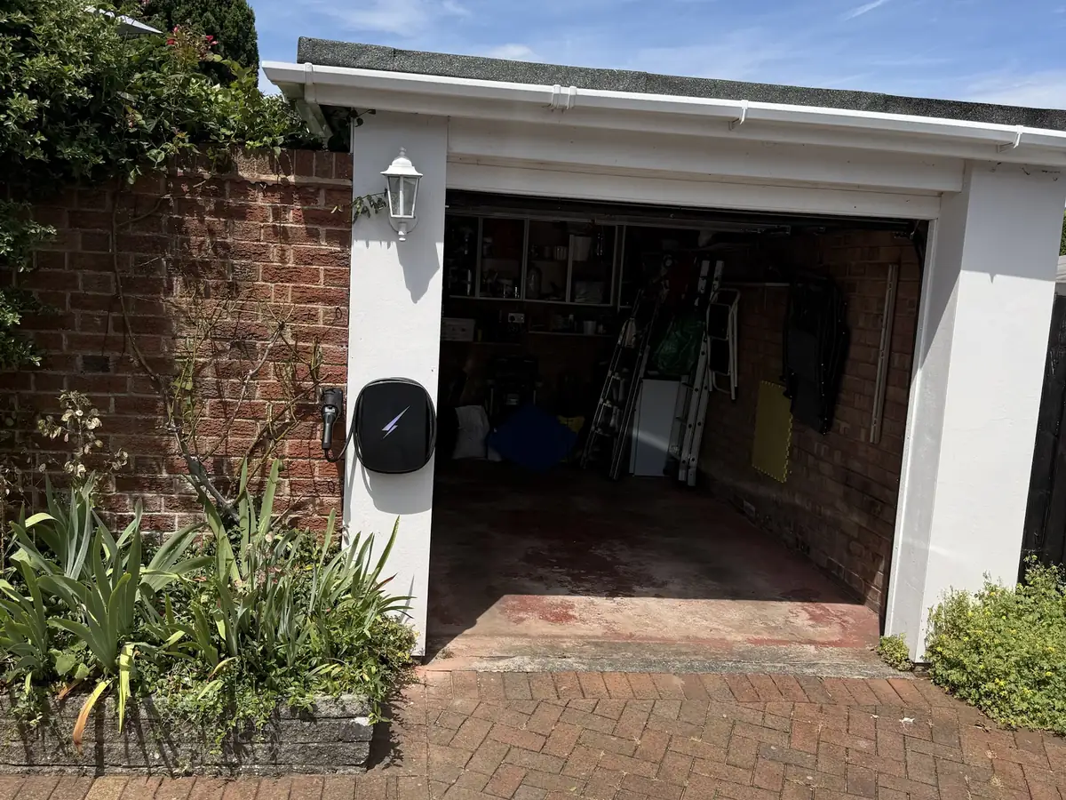 Home EV charger installed beside a garage by CT Electrical, OZEV-authorised installers