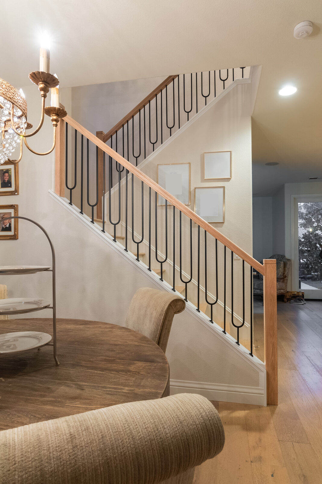 Grand curved staircase with white balusters and carpet runner, Roseville CA