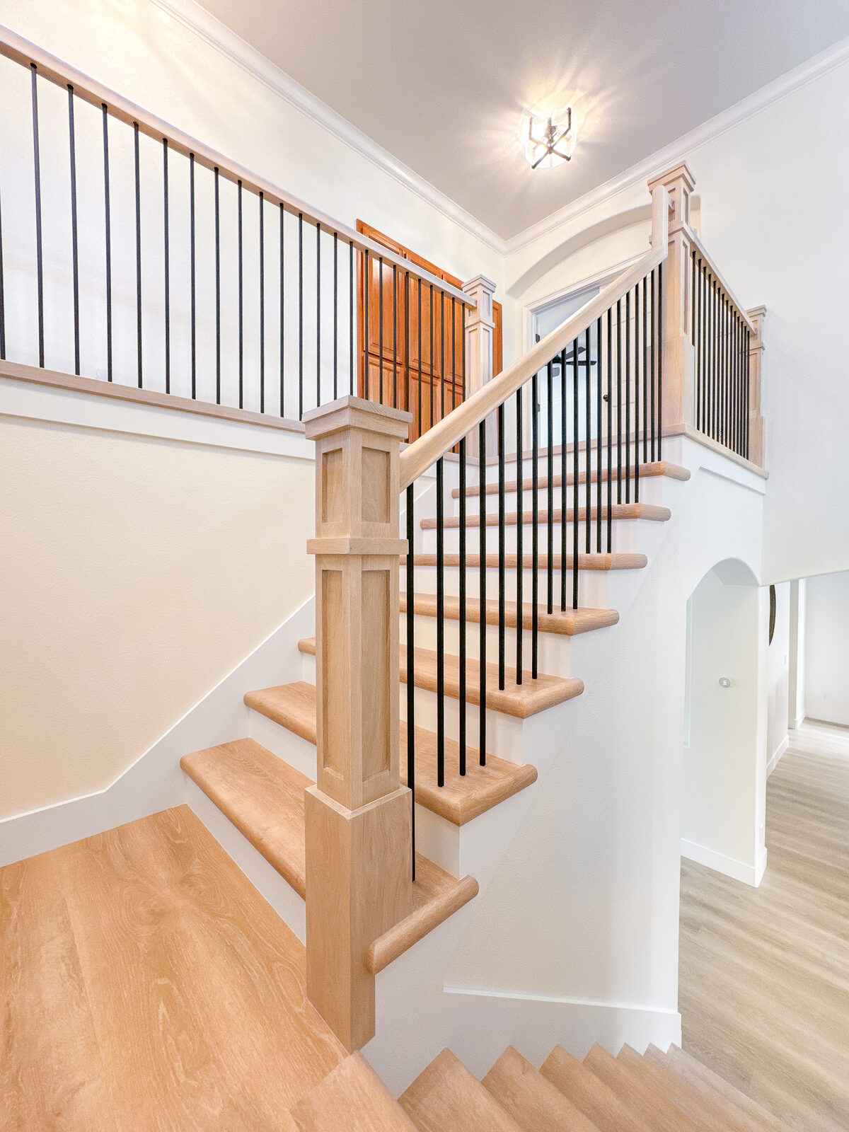 Full staircase remodel with black iron balusters and dark hardwood treads, Roseville CA