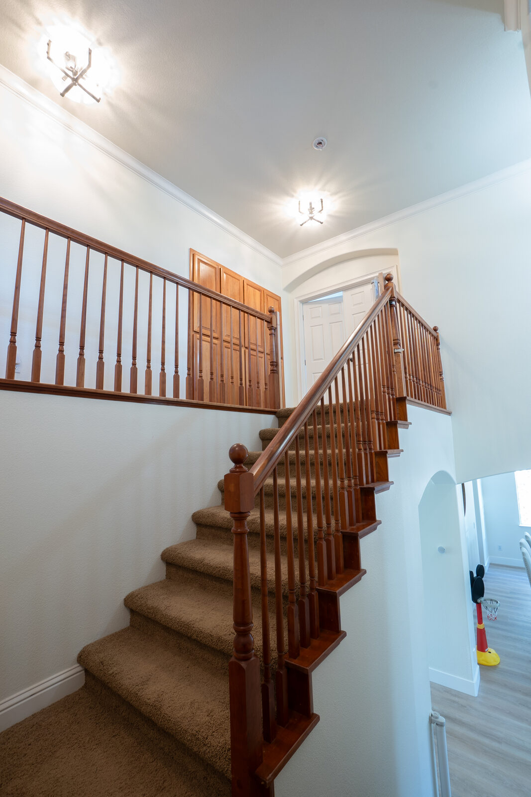 Carpeted staircase with dated wood balusters before remodel, Granite Bay CA