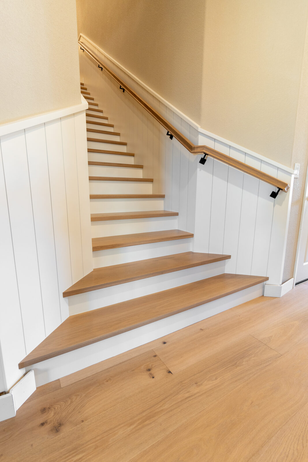 Staircase with hardwood treads and board-and-batten accent wall, Granite Bay CA