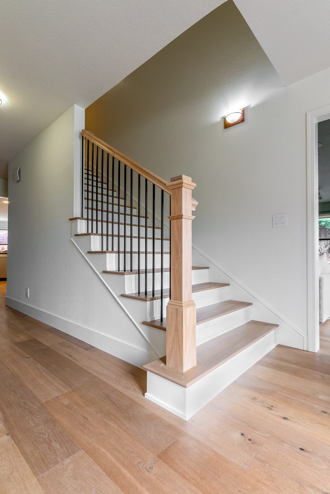 Staircase remodel with white balusters and wood newel post, Folsom CA